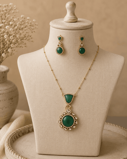 Emerald pendant necklace set with round teardrop centerpiece and matching drop earrings