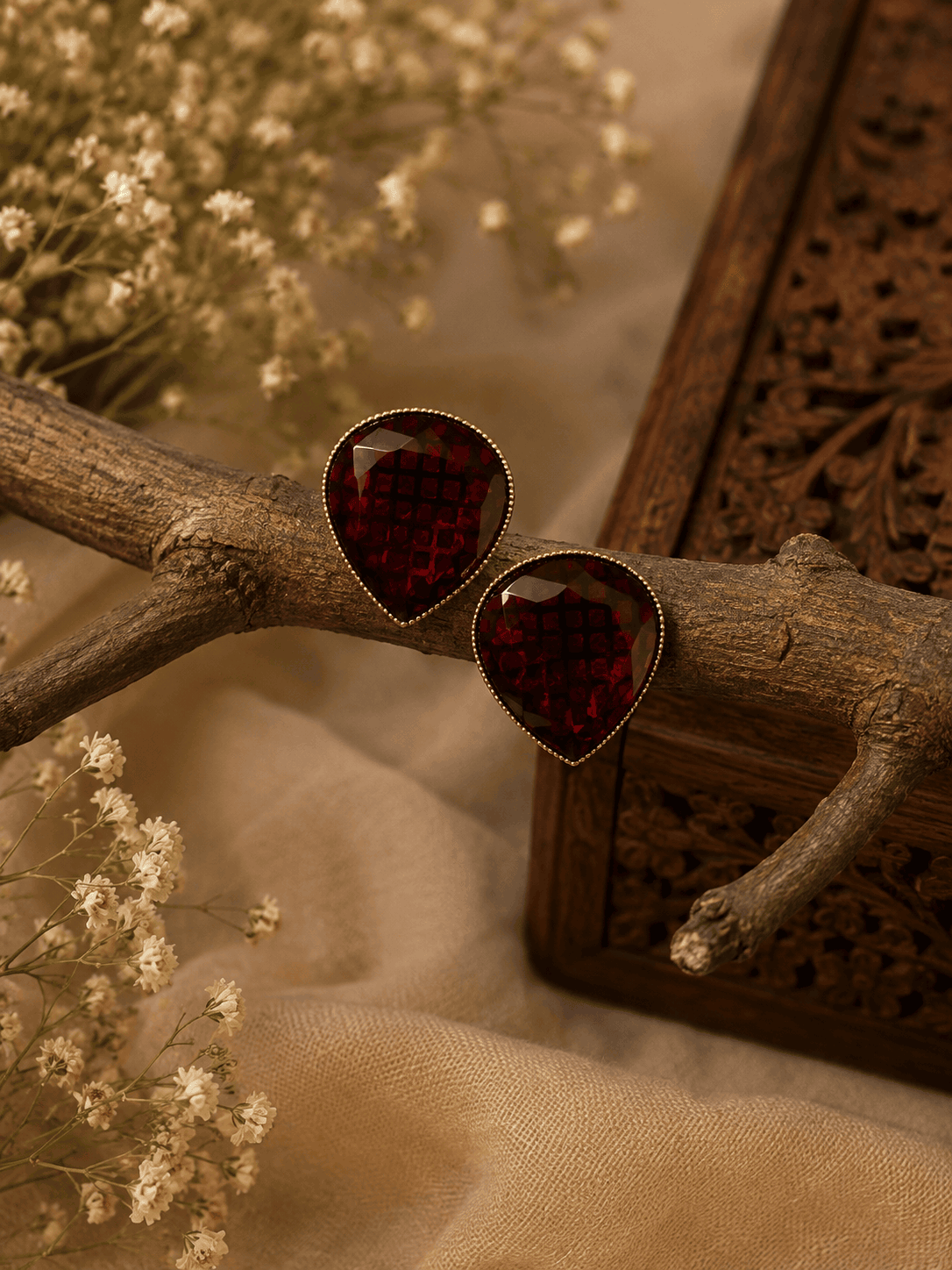 Wine red teardrop stud earrings with textured faceted stones