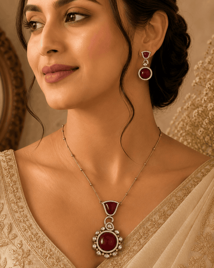 Wine pendant necklace with round center and matching drop earrings worn by model