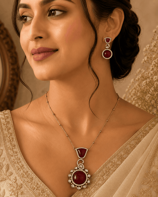 Wine pendant necklace with round center and matching drop earrings worn by model