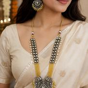 Gold-tone long necklace set with yellow center pendant and matching round earrings