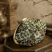 Black fabric clutch with green bead embroidery and gold clasp, side angle