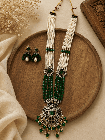 Emerald green beaded pearl necklace set with ornate pendant and stud earrings