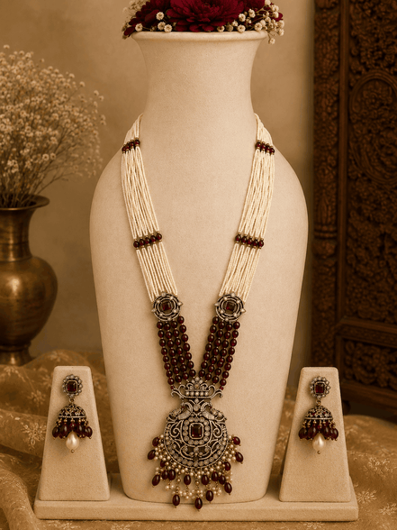 Maroon beaded pearl necklace set with ornate pendant and matching stud earrings