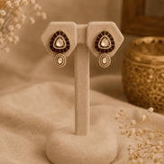 Gold stud earrings with black teardrop center and matching drop detail