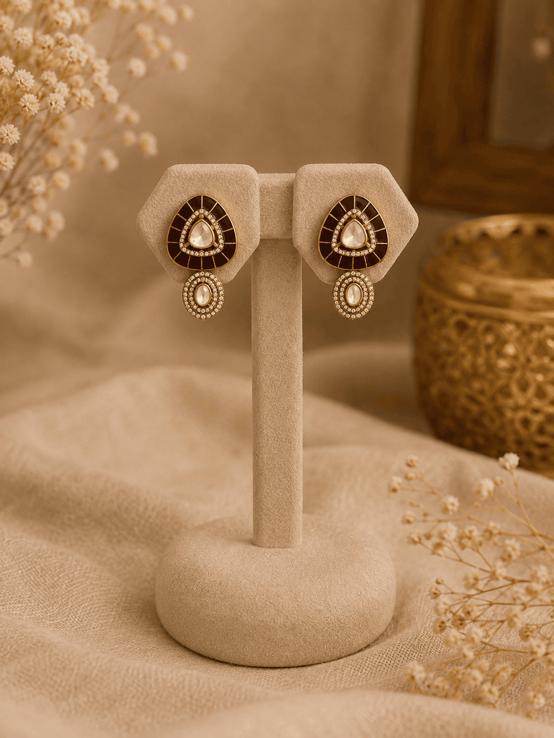 Gold stud earrings with black teardrop center and matching drop detail