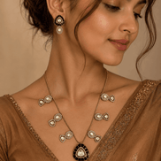 Black teardrop pendant necklace and matching earrings on model with gold chain
