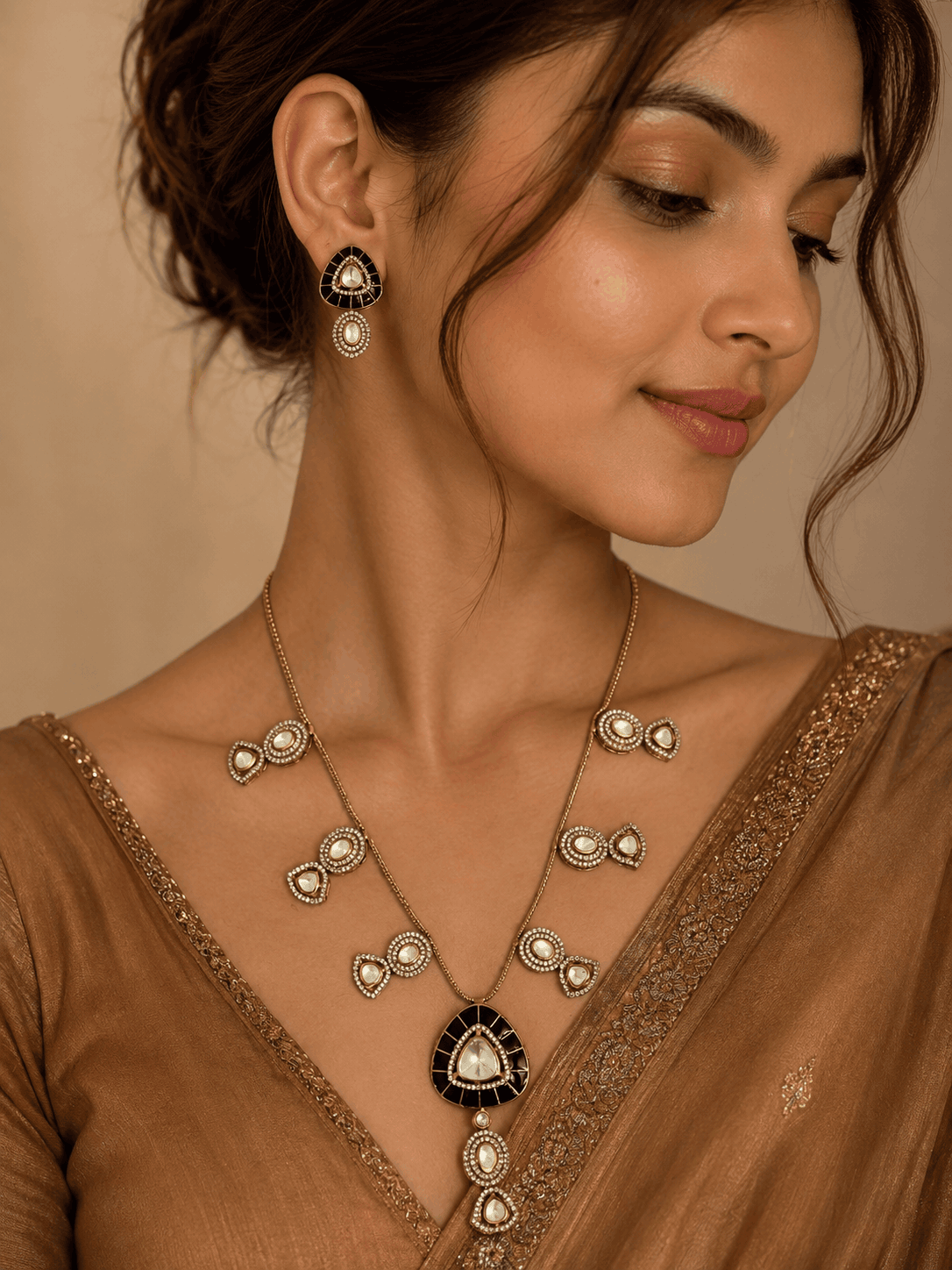 Black teardrop pendant necklace and matching earrings on model with gold chain