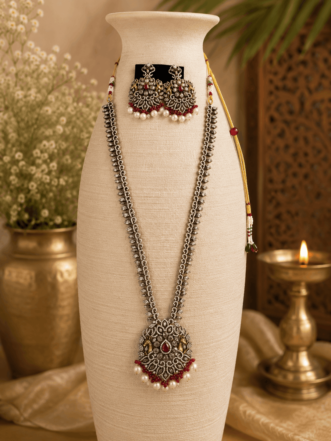 Wine necklace set bust view: layered silver-tone chains, maroon pendant, pearl jhumka earrings