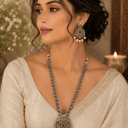 Wine statement necklace and earrings on model: silver-tone maroon pendant with dangling pearl drops