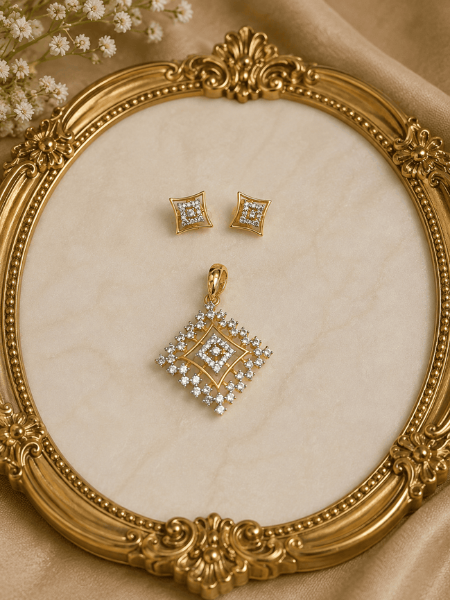 Gold-tone square crystal pendant and matching stud earrings on ornate jewelry display