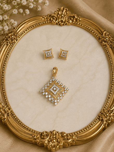 Gold-tone square crystal pendant and matching stud earrings on ornate jewelry display