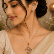 Gold-tone pendant necklace with square crystal pendant and matching stud earrings