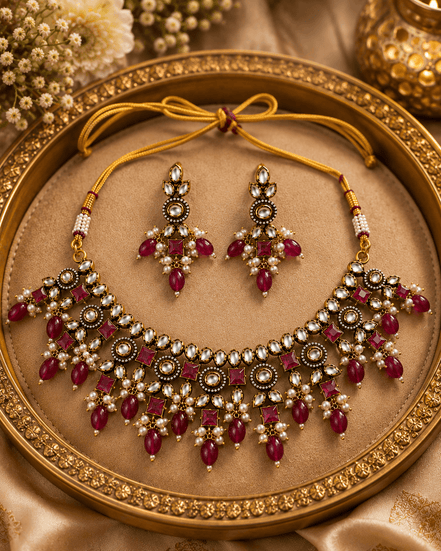 Gold-tone necklace set with maroon-red gemstone fringe and matching stud-and-drop earrings