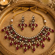 Gold-tone necklace set with maroon-red gemstone fringe and matching drop earrings