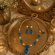 Blue teardrop pendant necklace set with matching drop earrings and pearl bead details