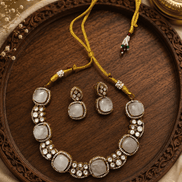Gold-tone gemstone necklace with round white stones and matching bead drop earrings