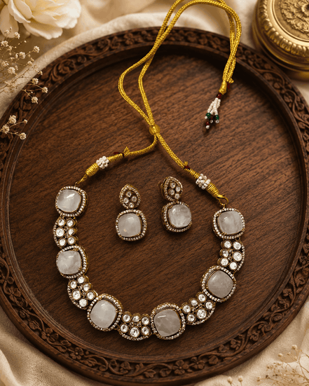 Gold-tone gemstone necklace with round white stones and matching bead drop earrings