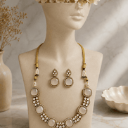 Gold-tone gemstone necklace with oval pendants and bezel stones, plus matching drop earrings