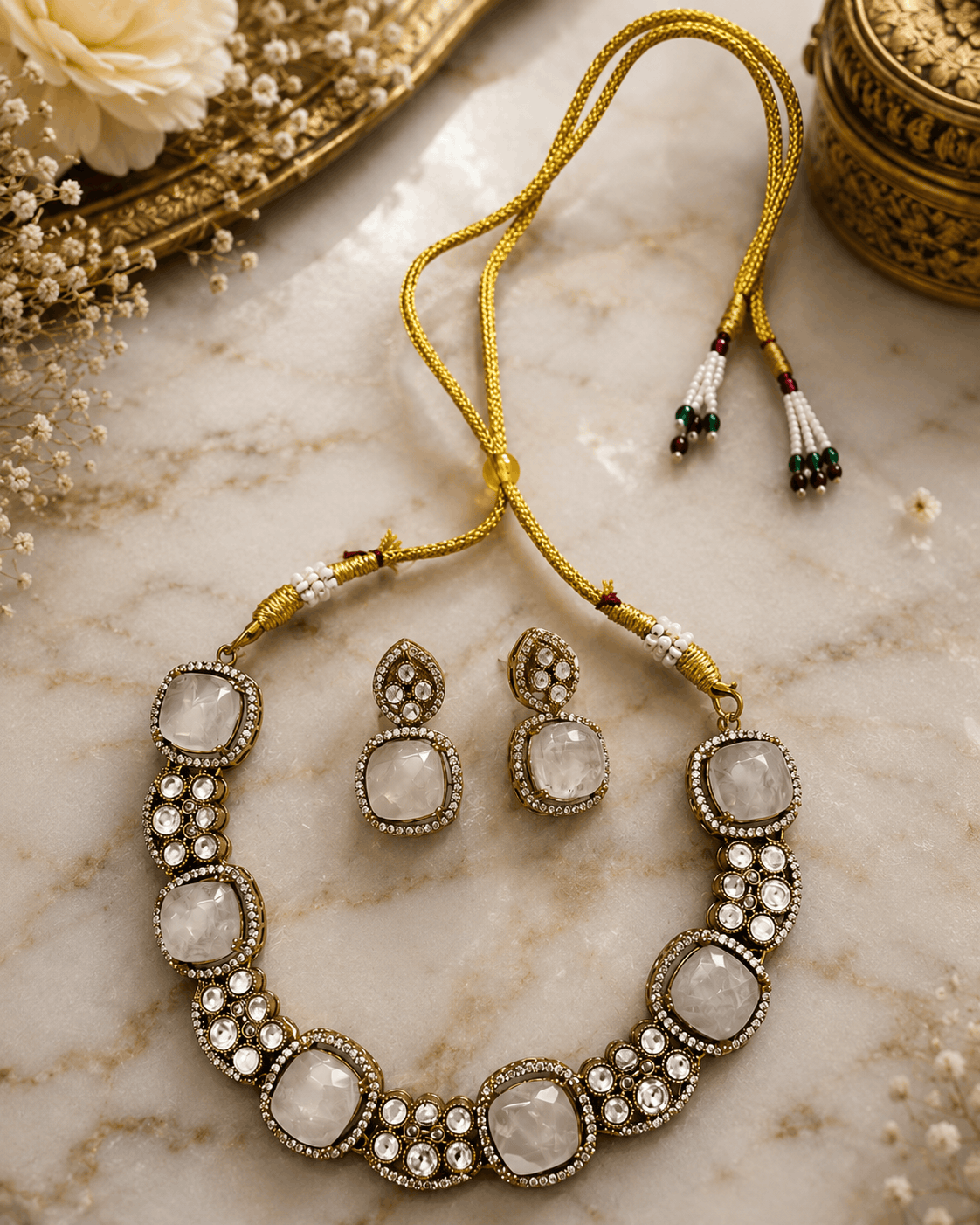 Gold-tone gemstone necklace with large oval white stones and round crystal accents