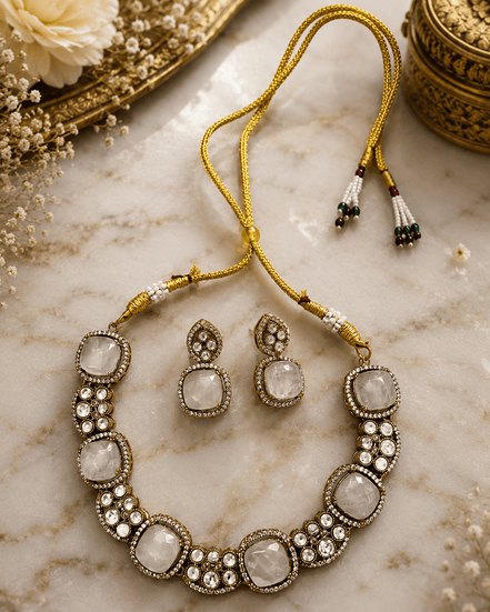 Gold-tone gemstone necklace with large oval white stones and round crystal accents