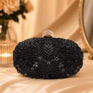 Black beaded clutch with gold-tone top frame and ornate beadwork