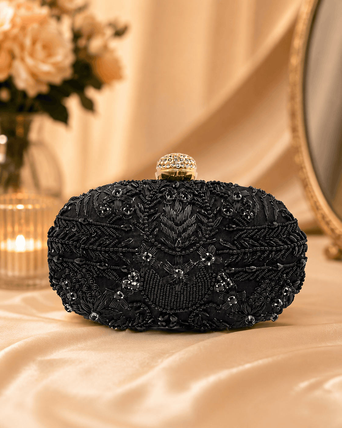 Black beaded clutch with gold-tone top frame and ornate beadwork