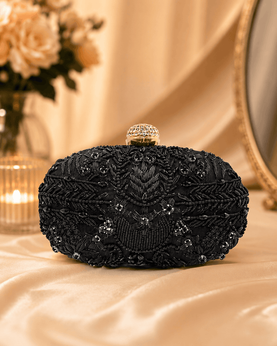Black beaded clutch with gold-tone top frame and ornate beadwork