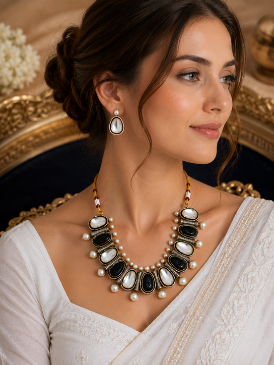 Mahira Heritage necklace set with black and white oval stones, pearls, and teardrop earrings.