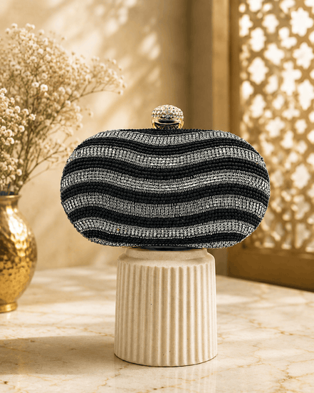 Black and white striped beaded clutch with gold clasp; rounded dome top.