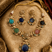 Gold-tone necklace and earrings set with blue, green, pink, and clear oval gemstones