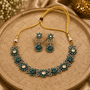 Peacock blue gemstone necklace set with floral detailing and matching drop earrings