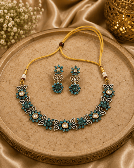Peacock blue gemstone necklace set with floral detailing and matching drop earrings