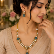 Gold kundan necklace set with peacock-blue oval pendants and matching drop earrings