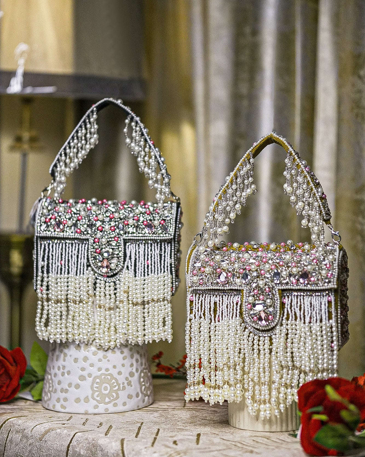 Pearl crystal fringe handbags, one black and one mustard, with jeweled tops and tassels