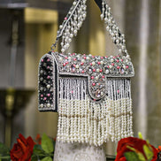 Black pearl crystal fringe handbag with jeweled flap, tassel fringe, and arched handle