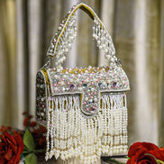 Pearl crystal fringe handbag with mustard trim, jeweled flap, and hanging bead strands