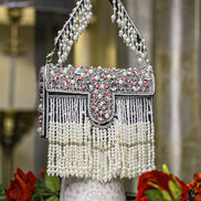 Black pearl crystal fringe handbag with arched handle, jeweled clasp, and dangling beads