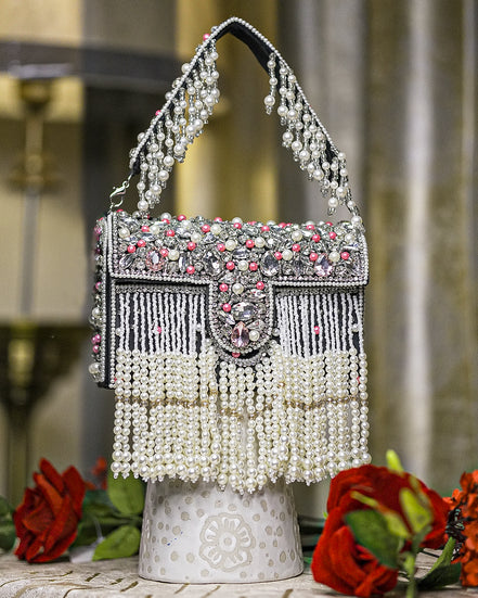 Black pearl crystal fringe handbag with arched handle, jeweled clasp, and dangling beads