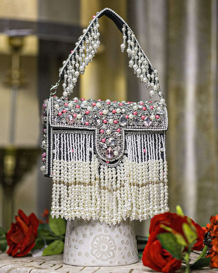 Black pearl crystal fringe handbag with arched handle, jeweled clasp, and dangling beads