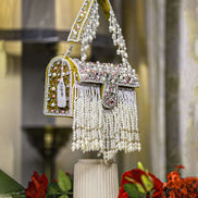 Mustard-trim pearl crystal fringe handbag with side tassel detail and arched handle
