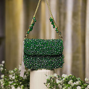 Emerald green crystal mini bag with top handle chain straps and decorative drop beads