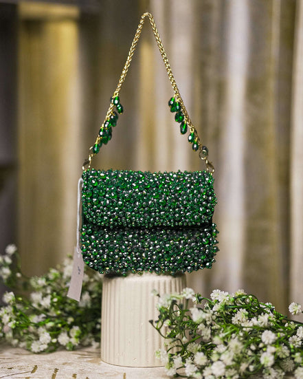 Emerald green crystal mini bag with top handle chain straps and decorative drop beads