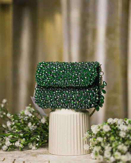 Emerald green crystal mini bag with flap closure and side beaded tassel details