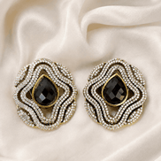 Brass-tone statement stud earrings with black teardrop center and sparkling crystal border