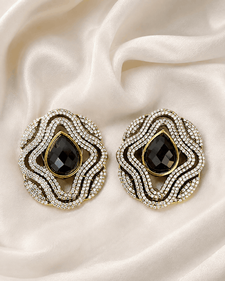 Brass-tone statement stud earrings with black teardrop center and sparkling crystal border