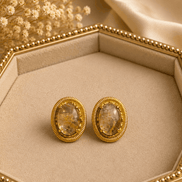 Oval amber/white stone stud earrings with gold-tone ridged bezel