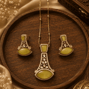 Gold-tone pendant necklace set with yellow teardrop earrings and ornate central pendant