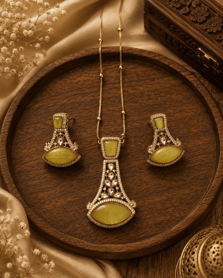 Gold-tone pendant necklace set with yellow teardrop earrings and ornate central pendant
