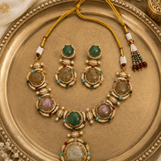 Gold-tone necklace set with round and oval gemstone earrings and a large pendant